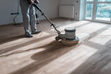 Person using a floor buffer on wooden floors